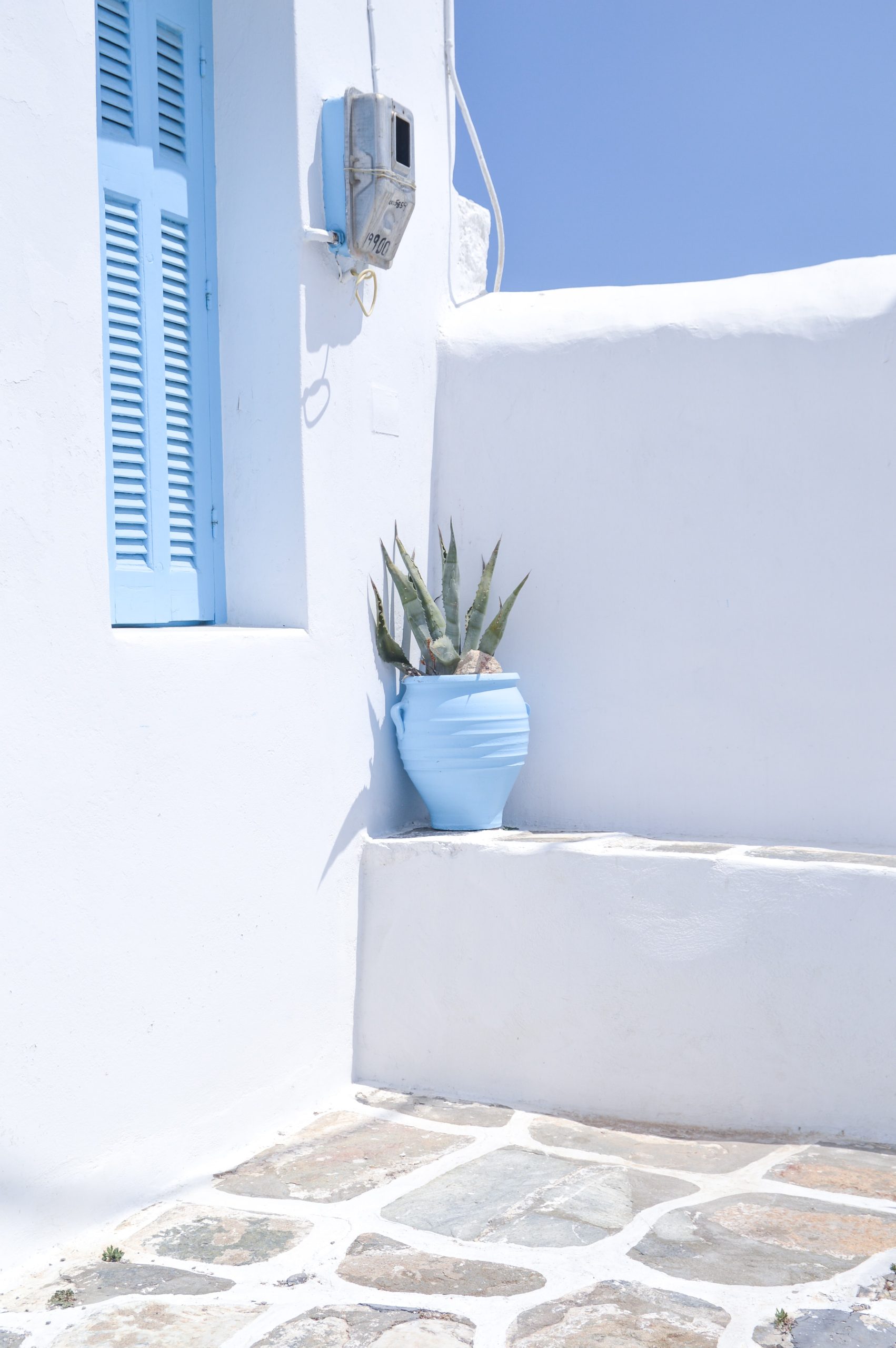 Greek balcony with urn in sun